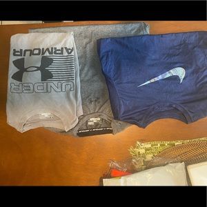 2 Under Armor and  1 Nike youth large boys shirts.